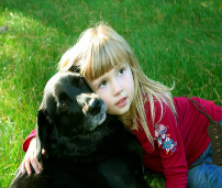 Picture of little girl hugging her dog